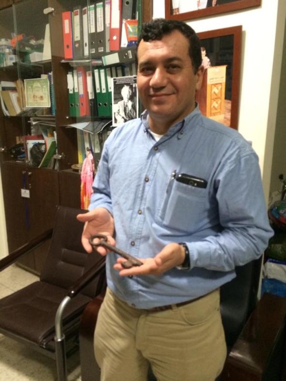 Dr. Abdelfattah Abusrour with the key to his family's home (it is a well-known custom for Palestinian families to keep the keys to the homes they lost during the Nakba as a sign of their hope for return.